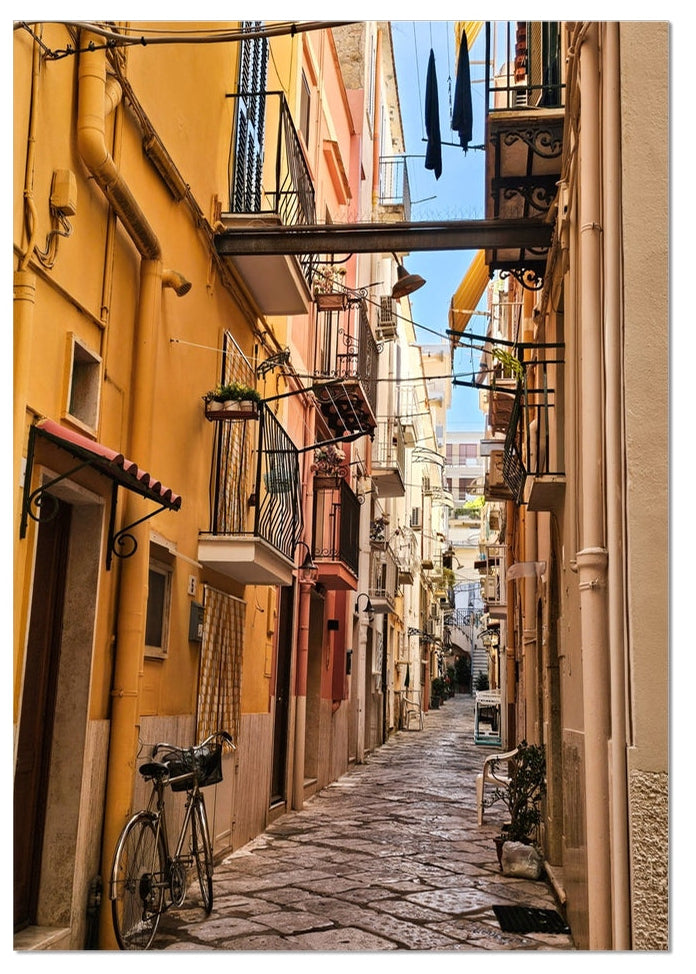 Il Vicolo fine art photograph of a narrow Italian alley with warm ochre buildings, balconies, washing and a bicycle