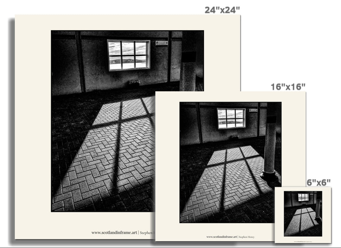 Contemporary photograph of the view through a rectangular window as the Sun was rising. Throwing light onto a brick floor.