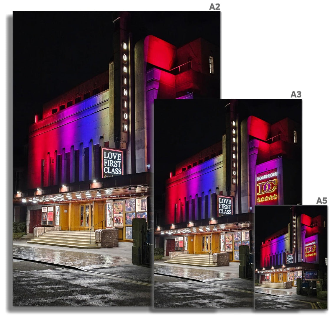 The Dominion Cinema in Morningside at night with neon light reflecting on wet streets, fine art photography print.