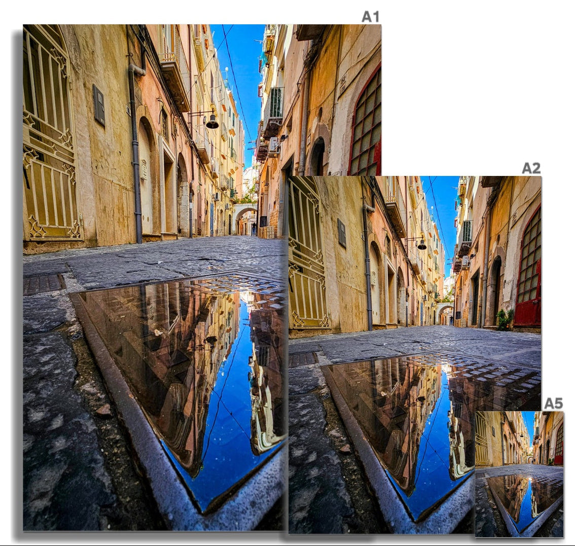 Dopo la Pioggia fine art photograph of colourful Italian buildings reflected in a puddle on an old cobbled street