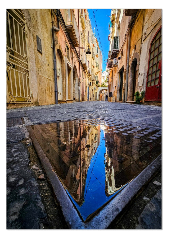 Dopo la Pioggia fine art photograph of colourful Italian buildings reflected in a puddle on an old cobbled street