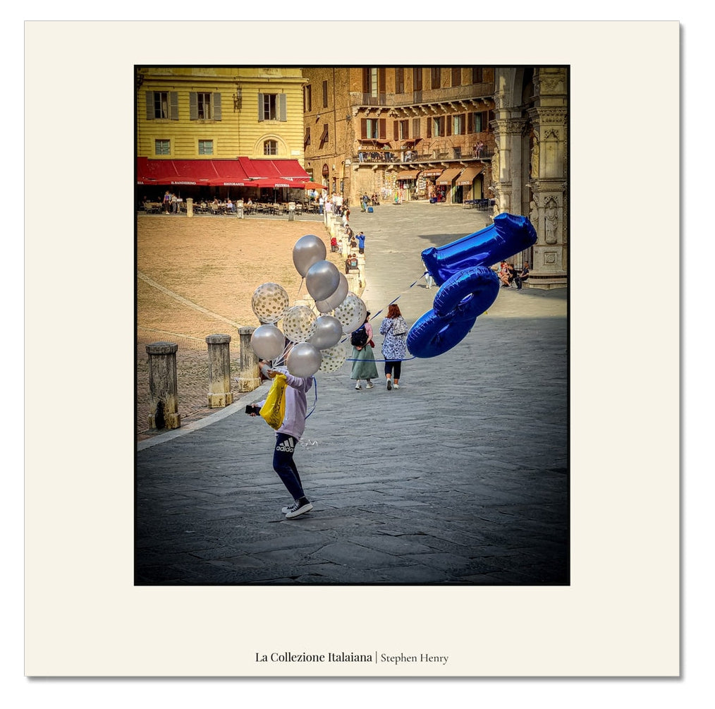 Fine art travel photograph of someone carrying 18th birthday balloons in Siena, Italy, part of the La Collezione Italiana wall art collection.